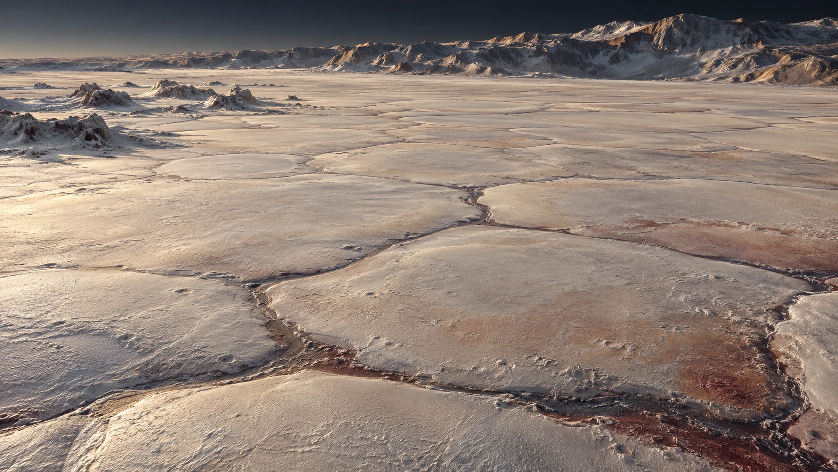 An interpretive low view crosses a pale polygonal ice plain toward distant rugged mountains and small scattered blocks.